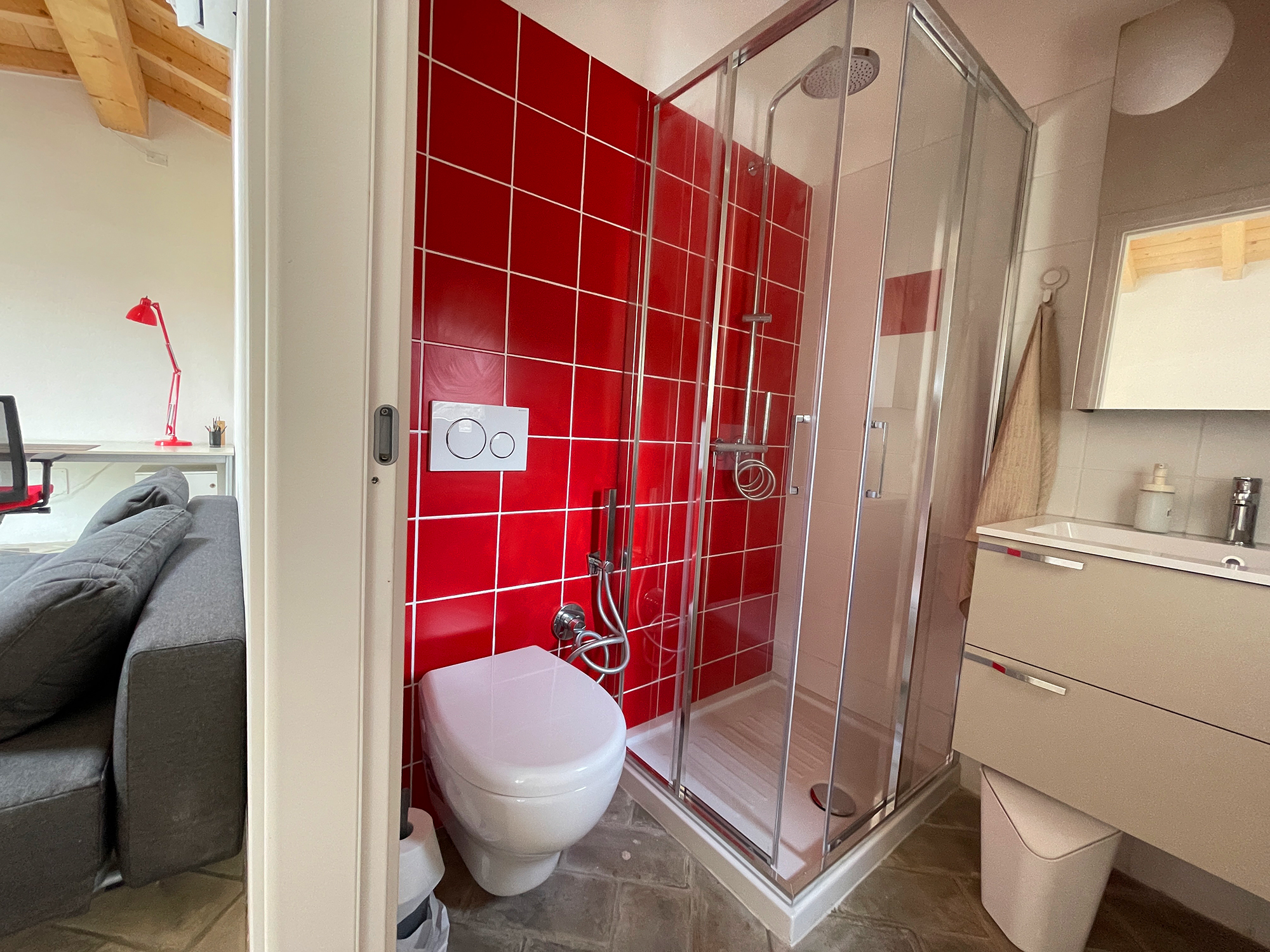 Podere Buriano, red bathroom in the studio. Design and photo © Barbara Fässler